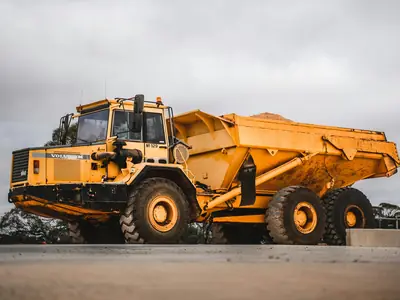 Gul ledad dumper på en asfaltplan
